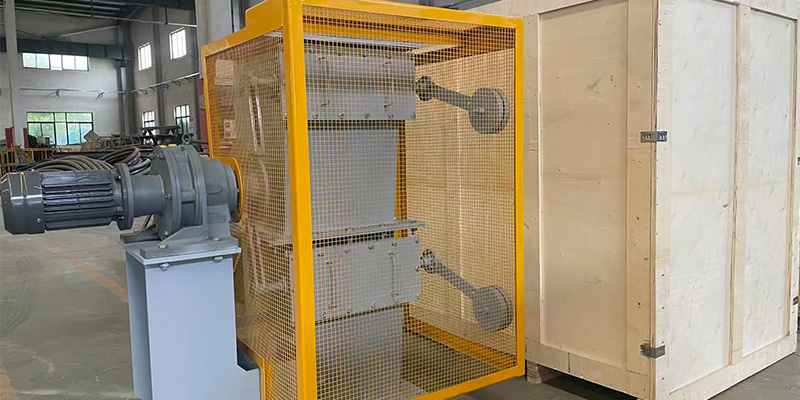 Electric motor‑driven double flap valve with safety guard for bulk material airlock discharge